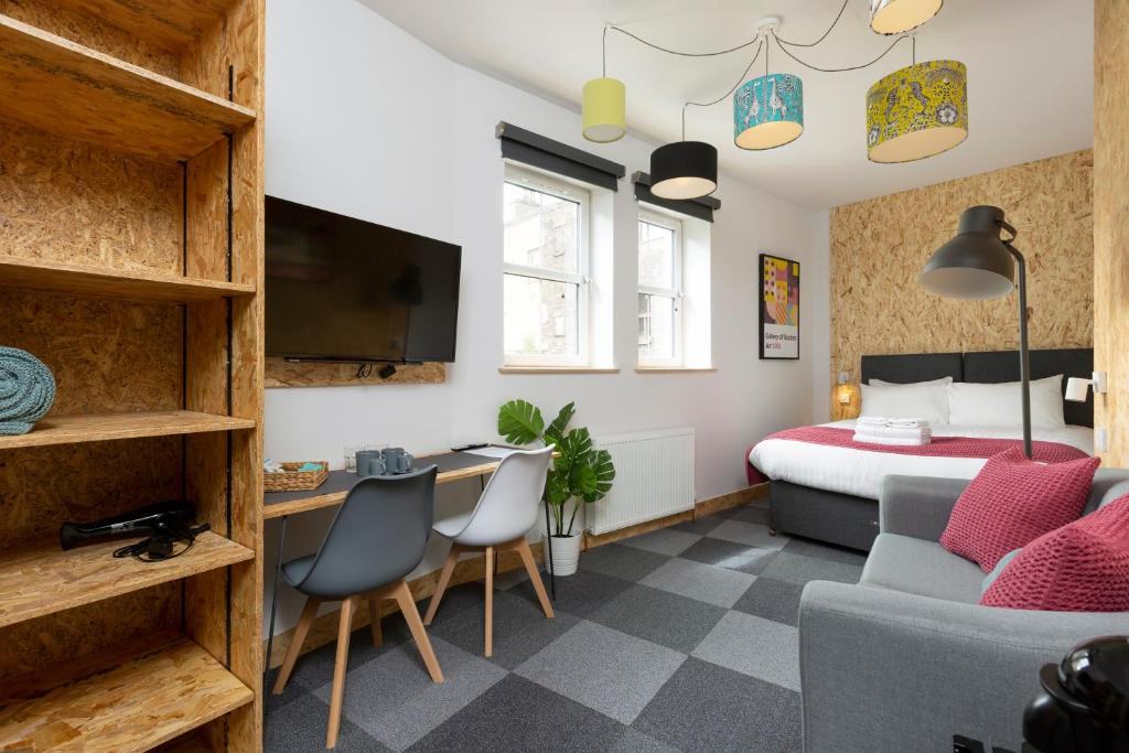 Bright On The Walk guest room with a bed, seating area and colourful ceiling lamps